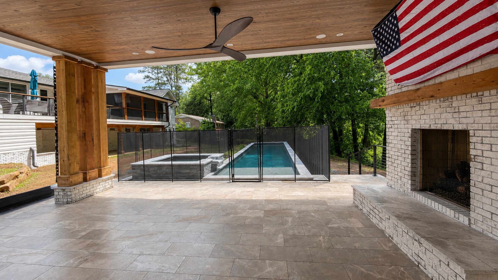 Covered terrace overlooking the pool and spa at the Alpharetta Pool Guest House
