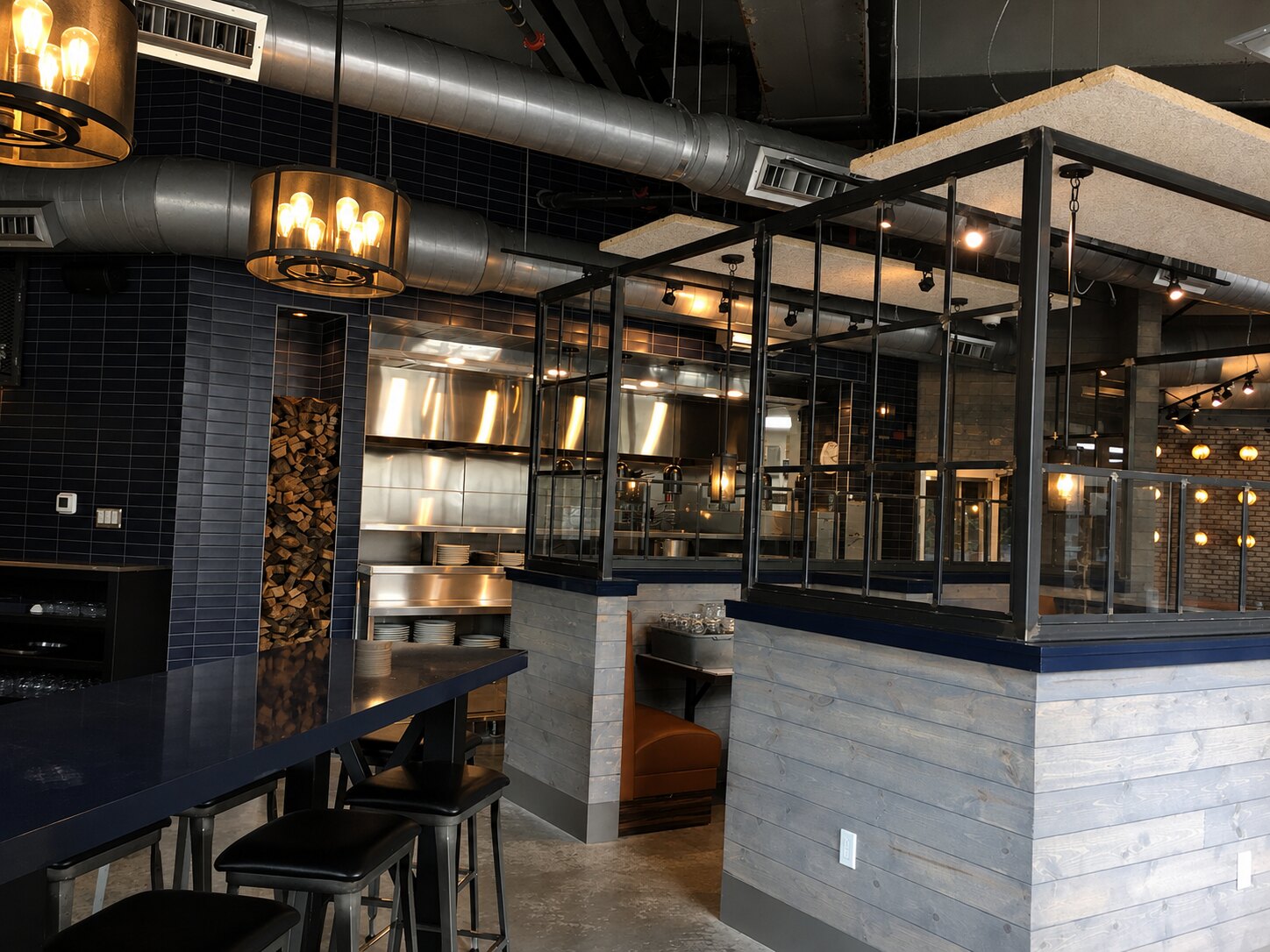 Completed open kitchen framed in steel and glass at Coalition Food and Beverage