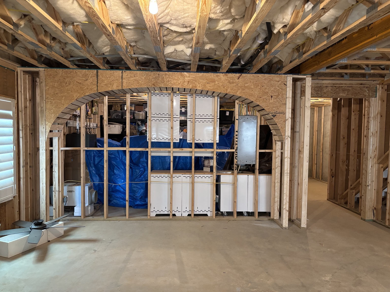 Arched opening being framed during a terrace-level renovation