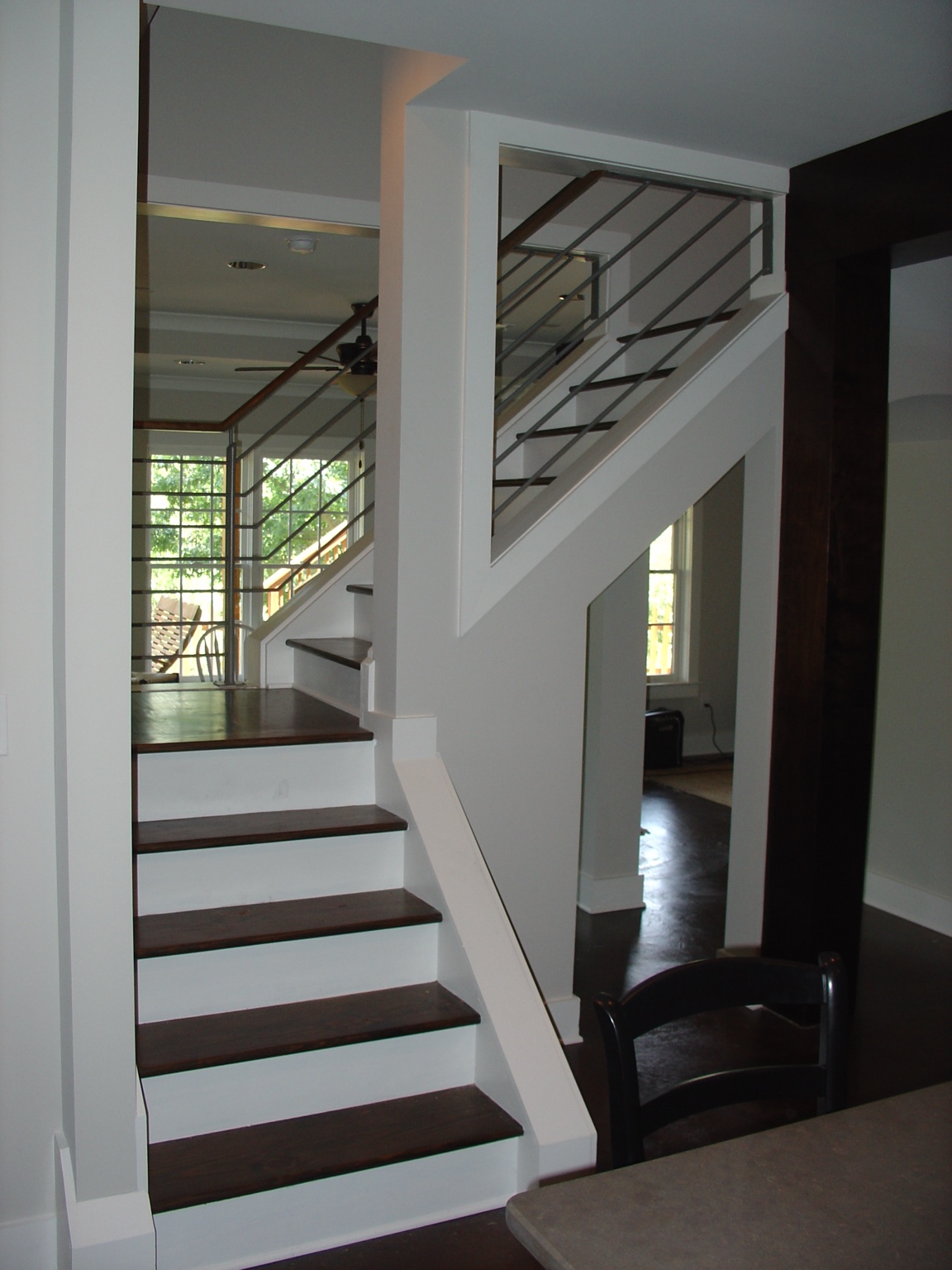 Open basement stair with wood treads and modern metal railing