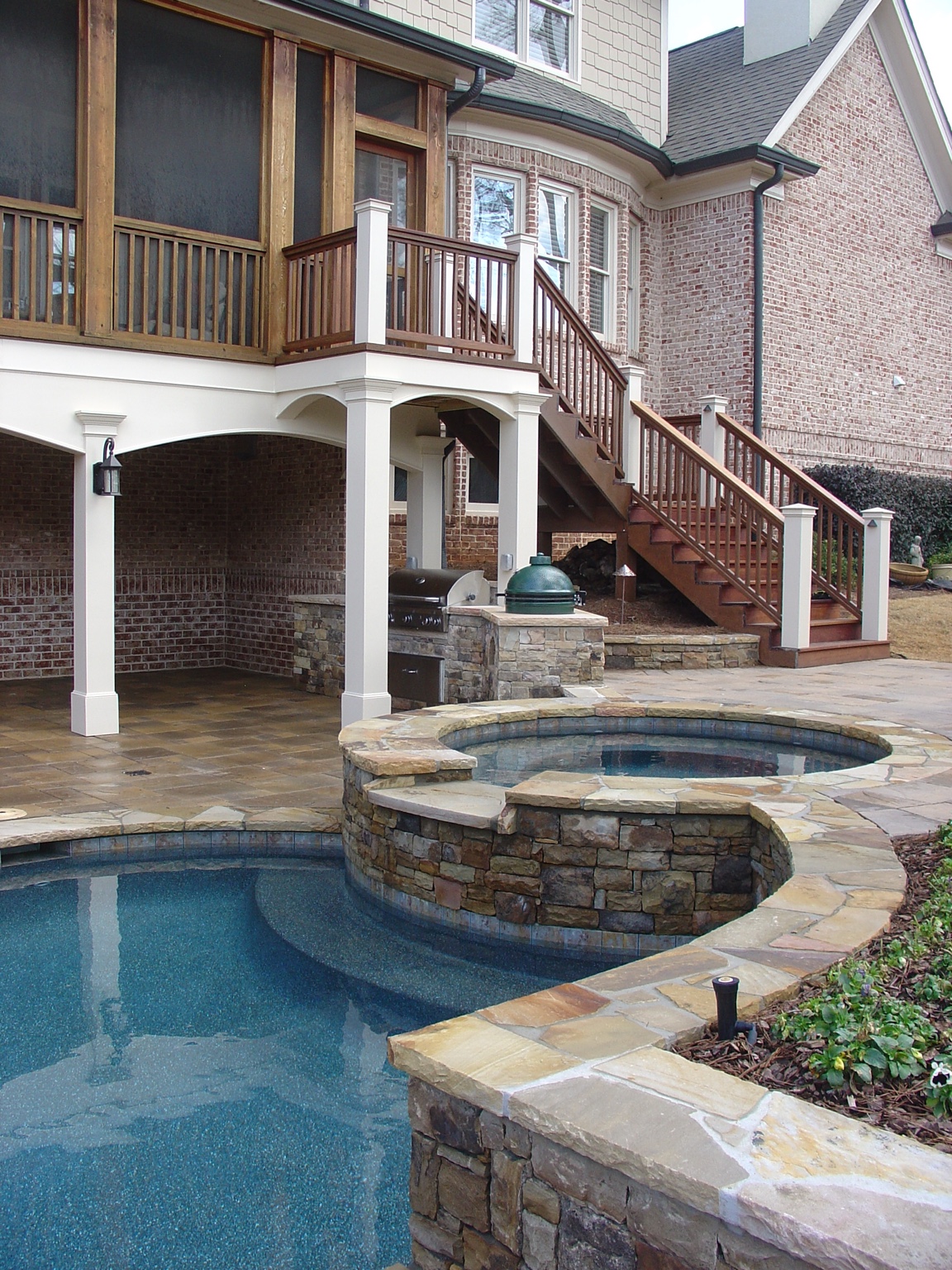 Pool and elevated porch integrated into a residential addition
