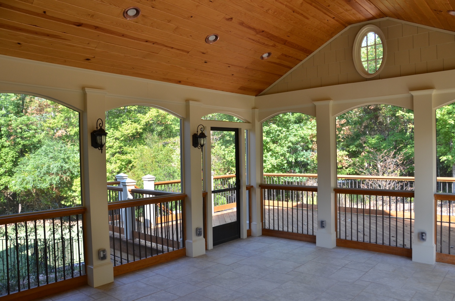 Completed screened porch with wood ceiling and broad openings